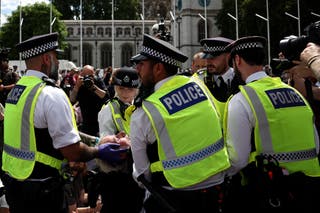 A protester is carried away by police officers